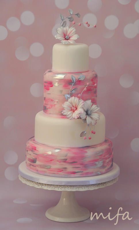 A Quinceanera cake, a three tiered cake with flowers on top