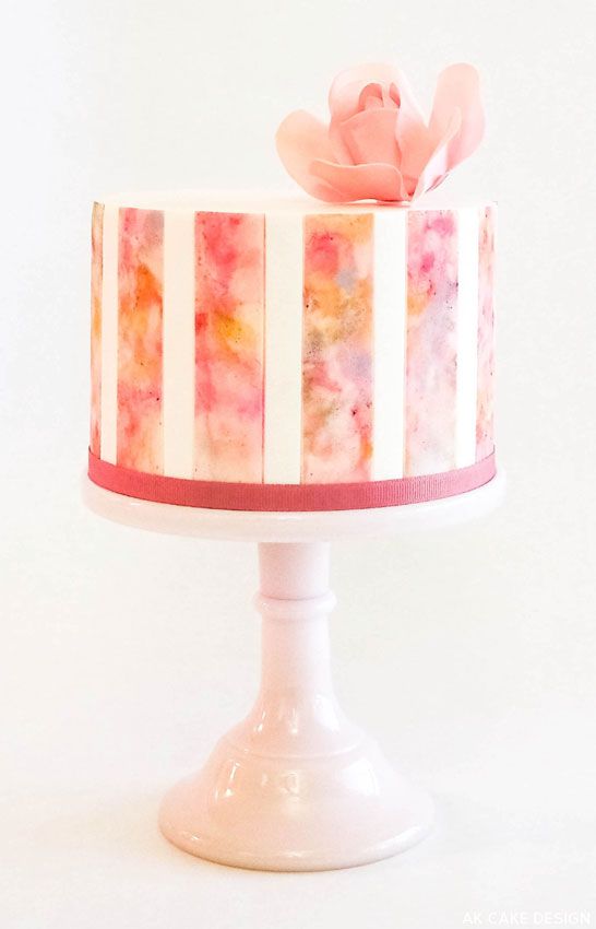 Watercolor cake, a white cake with a pink flower on top, perfect for a Quinceanera celebration