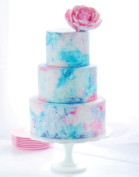 Eye-catching Quinceanera cake with three tiers and a pink flower on top