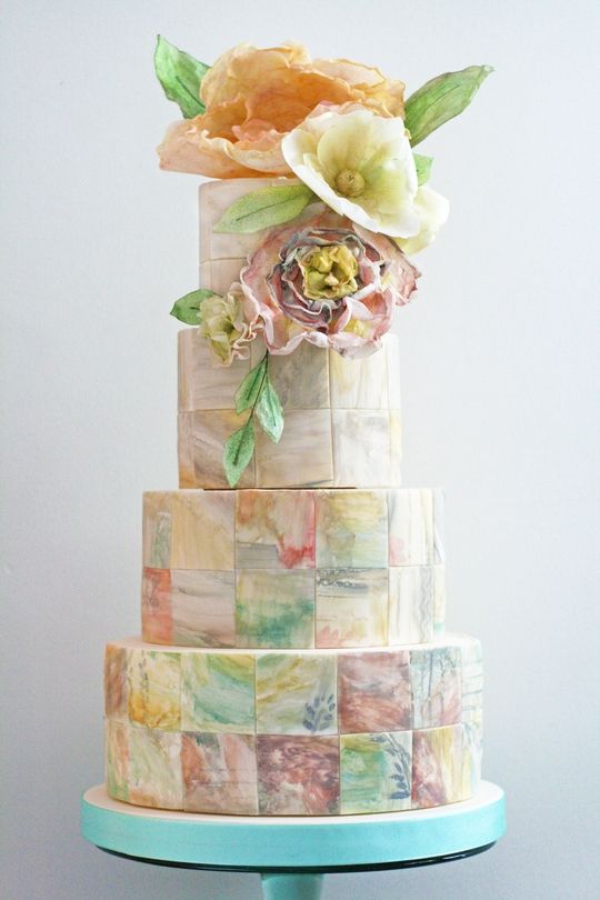 A Quinceanera cake, a three-tiered sugar cake with flowers on top