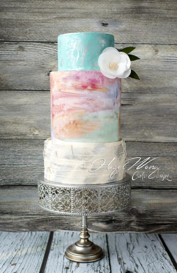 Quinceanera cake, a multicolored cake with a flower on top
