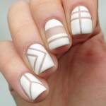 Quinceanera image: Nail designs with geometric patterns. A person showcasing a white manicure and white nail polish.