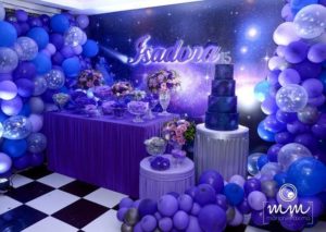Quinceanera: An out of this world themed party with purple and blue balloons