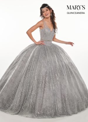 A woman in a ball gown posing for a picture, wearing Quinceañera dresses.