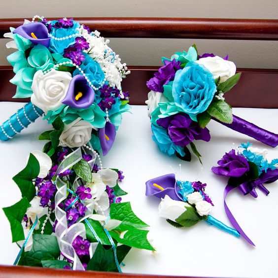 A Quinceanera flower bouquet and wedding invitation, with a bunch of flowers on a table