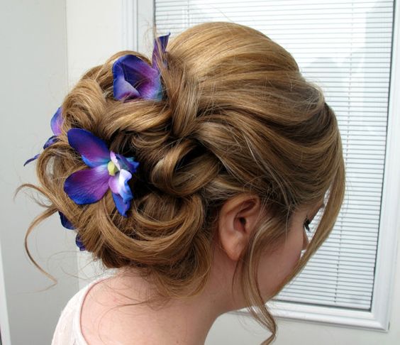 Quinceanera: A woman with a flower in her hair wearing a hair tie