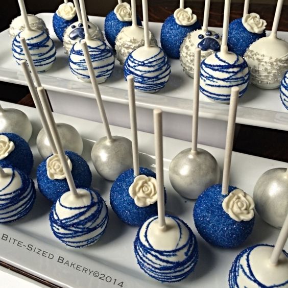 A display of dark blue and white Quinceanera cake pops