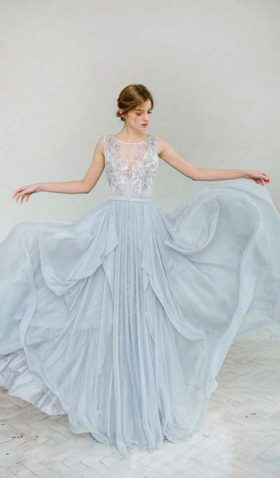 Quinceanera, a woman in a light blue dress is posing for a picture