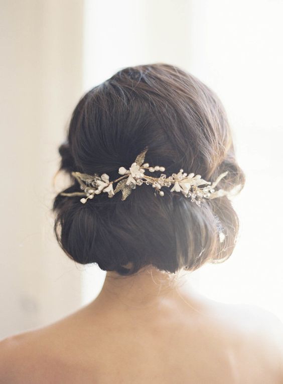 Close up of a woman with a hair comb wearing a Quinceanera chignon hairstyle