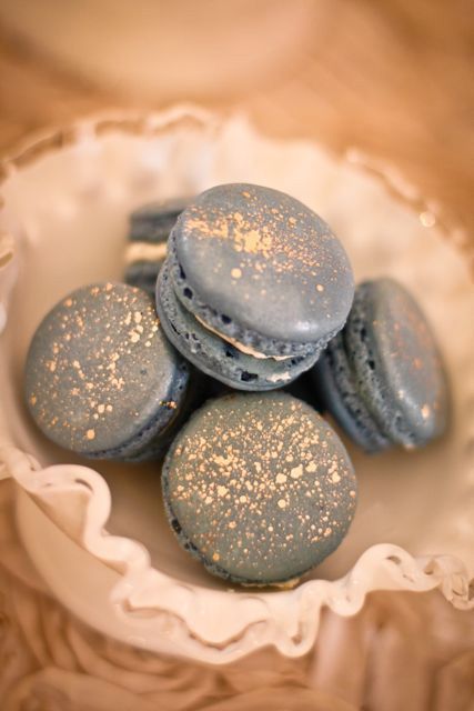 A celestial macaron Quinceanera theme: A white bowl filled with blue macarons on top of a table