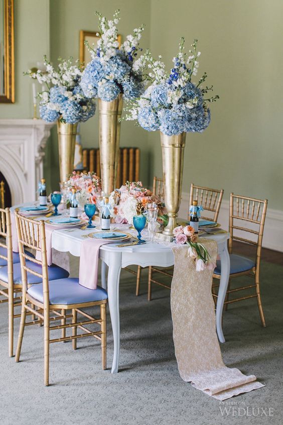 Light blue Quinceanera decorations including Quinceañera dresses and a dining room table adorned with blue and white flowers.