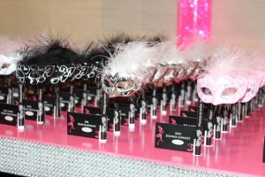 A Quinceanera table set with a variety of black and white items on a pink table