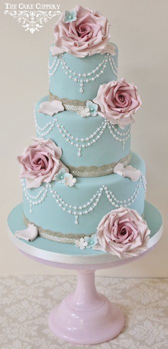 Quinceanera cake, a three tiered cake with pink roses and pearls