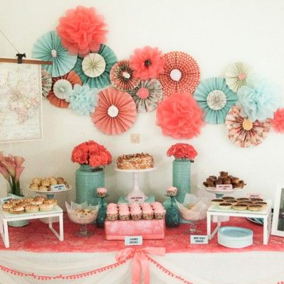 A Quinceanera celebration with a floral theme. The venue is adorned with beautiful petals and paper lanterns hanging from a tree.