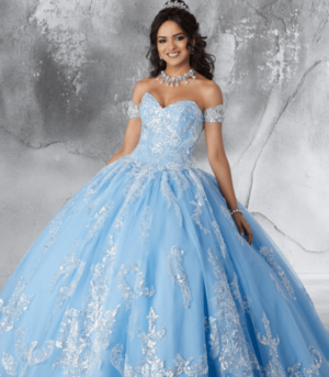 A woman in a blue Quinceanera gown posing for a picture.