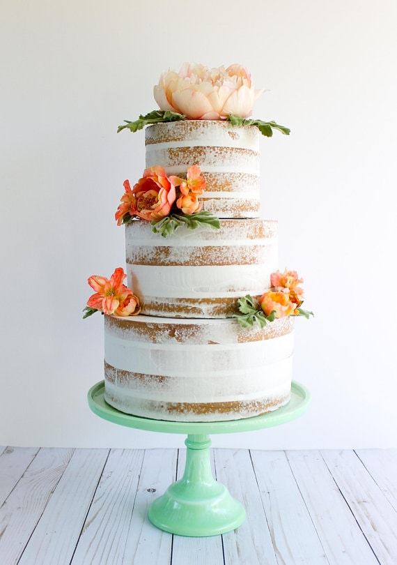 A three-tiered Quinceanera cake with flowers on top
