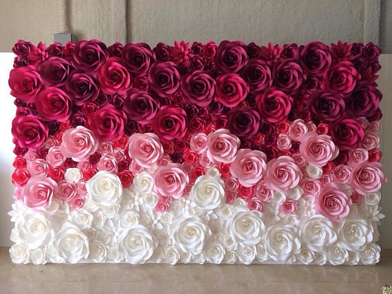 Quinceanera paper flower backdrop, a close up of a flower wall on a table
