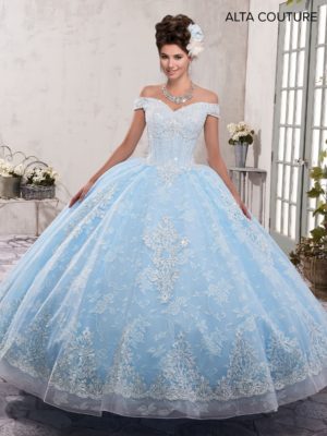 A woman posing for a picture in a blue ball gown Quinceañera dress