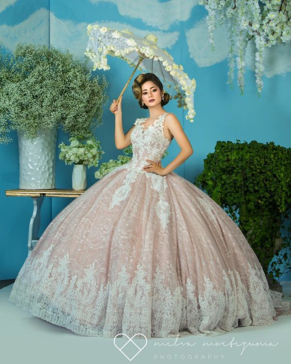 A woman in a ball gown posing for a photo in gown Quinceañera dresses