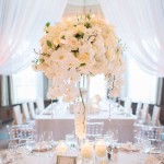 Floral design centerpiece for a Quinceanera event, featuring a table with a vase filled with white flowers