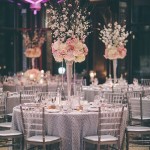 Table with a bunch of chairs and flowers, perfect for Quinceanera celebration