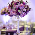 Quinceanera centerpiece, a tall vase filled with lots of purple flowers