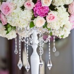 A beautiful Quinceanera floral arrangement consisting of pink and white flowers, elegantly displayed in a white vase.