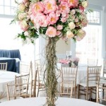 Floral design featuring a tall vase filled with lots of pink flowers for a Quinceanera