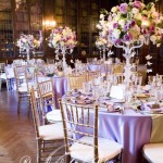 Quinceanera table decor featuring lavender accents in a grand room with chandelier