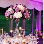 Quinceanera centrepiece, a table with a vase of flowers on it