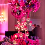 A beautiful Quinceanera centrepiece featuring a table adorned with a vase of flowers and candles.