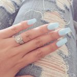 A person with a ring on their finger wearing ballerina pastel blue nails, perfect for a Quinceanera celebration.