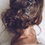 Quinceanera hairstyle with hair accessories: A woman with a hair comb in her hair.