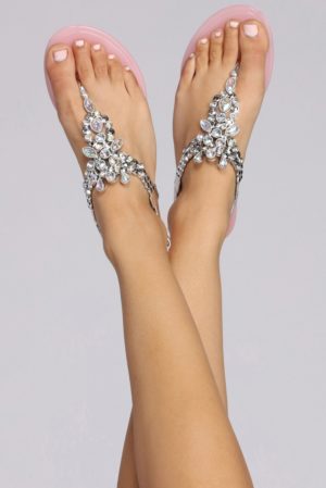 Quinceanera jewellery, a woman's legs with a pair of pink sandals