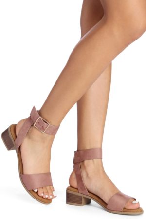 A pair of high heeled pink sandals worn by a woman at a Quinceanera.