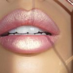 Quinceanera: A close up of a woman's lips with a mirror in the background, wearing Milani Color Statement Lipstick