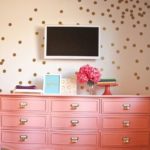 Quinceanera-themed image of a coral gables paint, featuring a pink dresser with a television on top of it