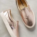 Quinceanera: A pair of metallic shoes on a marble surface