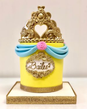 A Quinceanera cake with a crown on top