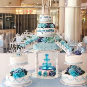 Quinceanera cake, a table topped with three tiered cakes covered in frosting