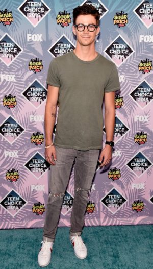 A man wearing glasses and a green shirt, Grant Gustin