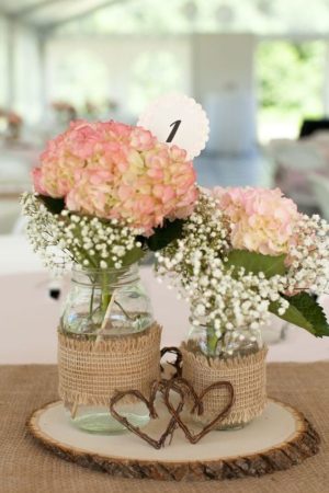 Quinceanera image: Bridal shower, a couple of vases filled with flowers on top of a table