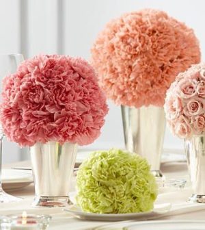 Quinceanera image: A group of vases filled with pink and green flowers
