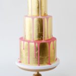 Quinceanera themed metallic cake, featuring three tiers with gold and pink icing