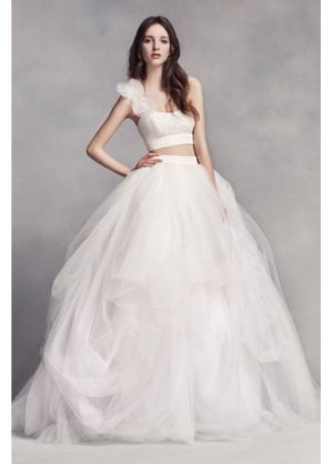 A woman in a Quinceanera gown posing for a picture