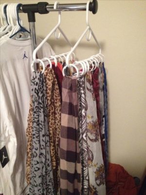 A rack with Quinceanera clothes hanging on clothes hangers in a room
