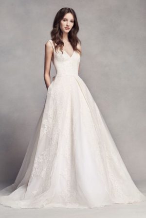 A Quinceanera girl in a beautiful dress posing for a photo