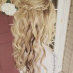 Quinceanera hairstyle with extensions, a woman with long blonde hair standing in front of a door