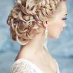 A woman in a white dress with a complicated Quinceanera hair comb, wearing a braid updo