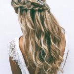Quinceanera hairstyle, a woman with long blonde hair and a flower in her hair